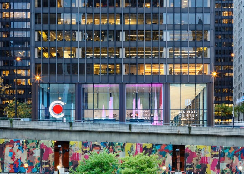 Image of the facade of a black building with tall windows and a "C" on the face of it.