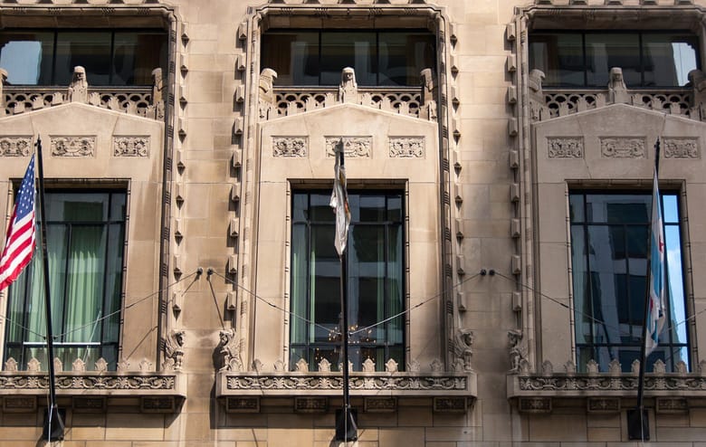 Front view, close up of the front of a terra cotta building with large windows