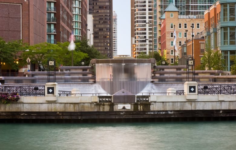 Waterfall-like fountain in front of tall skyscrapers