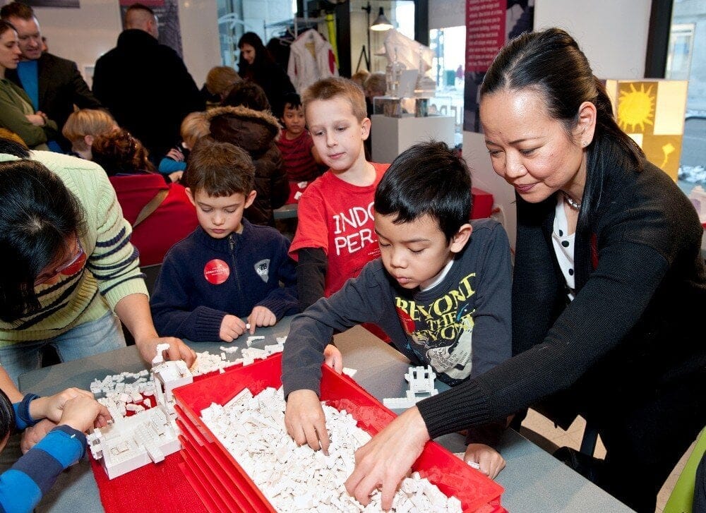 Adults and Children building with legos together