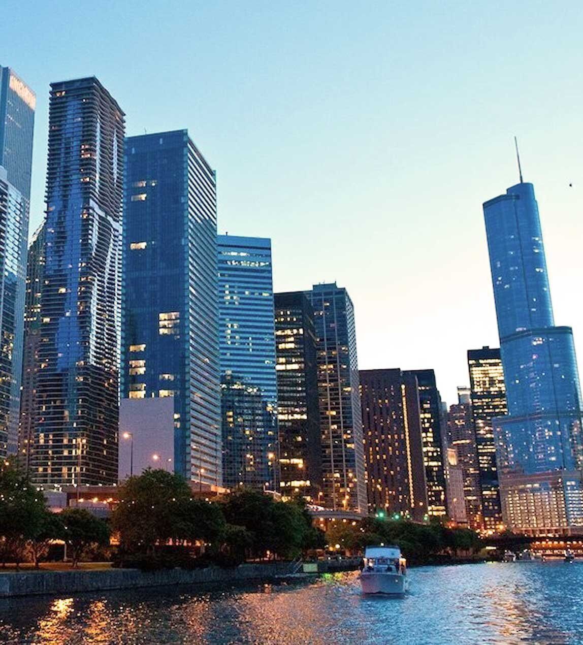 River cruise in the late evening with skysccrapers surrounding river