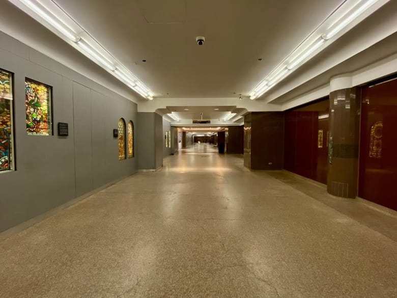 Image of a hall with stain glass on one wall