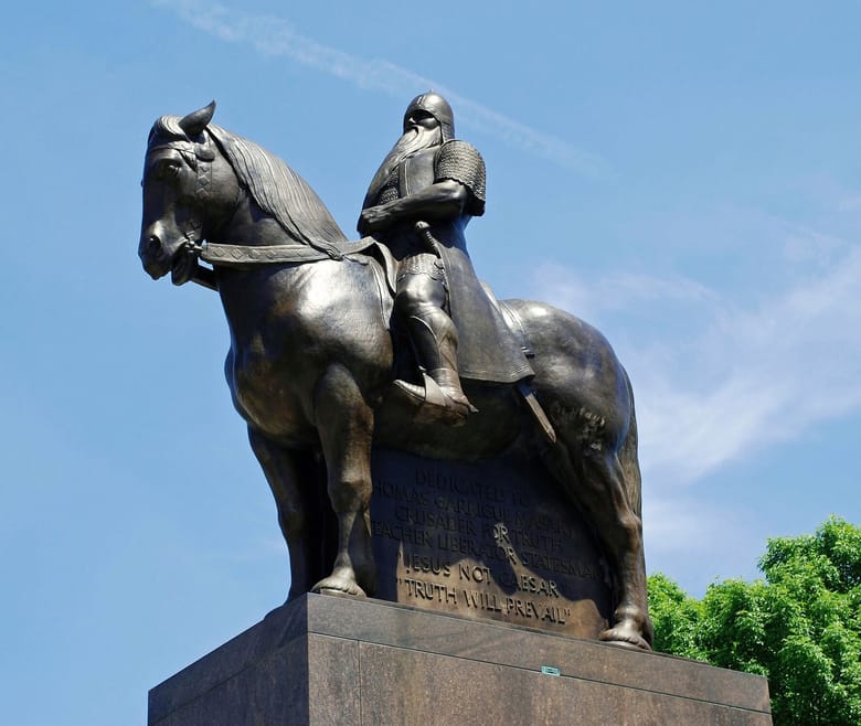 A photo of a metal statue of a man on horseback. 