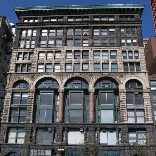 Exterior of multi story building with arched windows