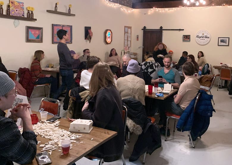 A few tables of people building with LEGOS