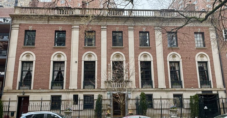 Large red brick building with white columns