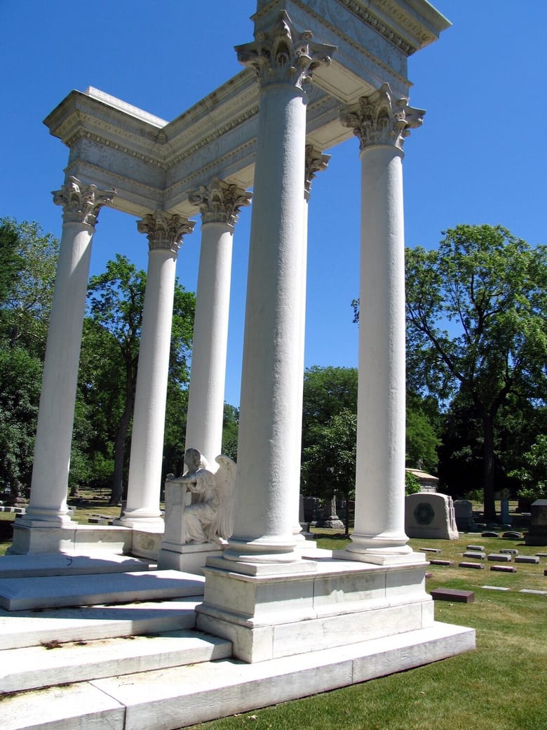 Roman columns in the midst of grass.