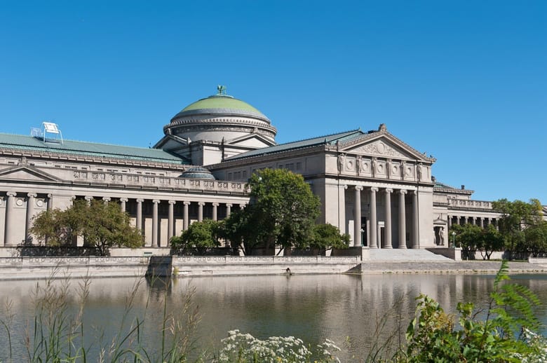 Exterior view of the Museum of Science and Industry in Chicago, featuring its historic architecture with ornate details and a large dome.