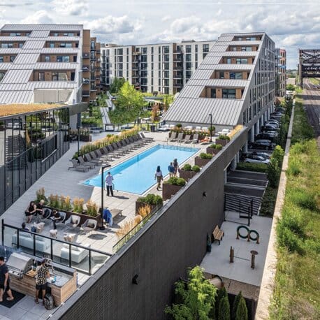 Exterior of a modern building with a pool on top