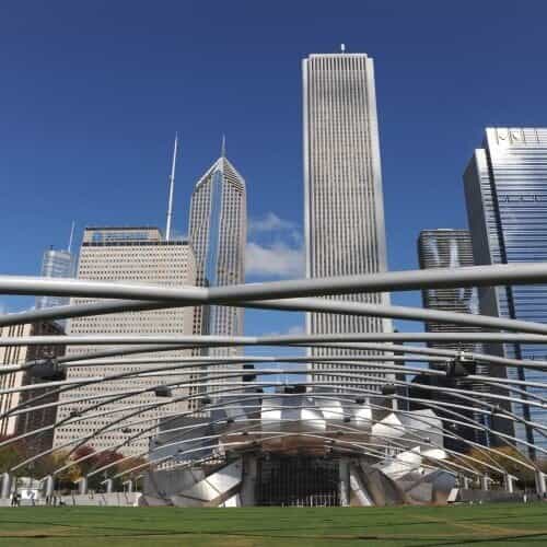 looking up at chicago skyscrapers from view of pritzker pavilion