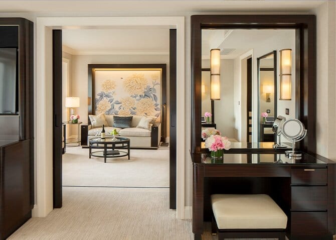 Interior of an elegant hotel room with dark wood and floral theme