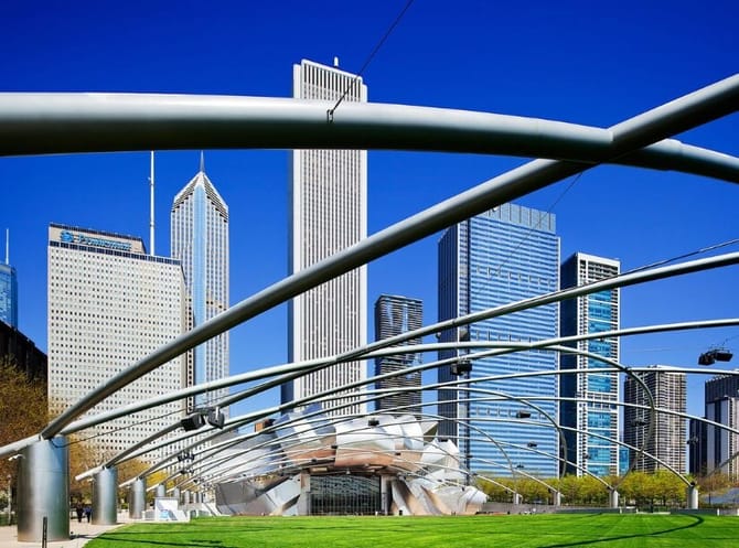 Boats in the river with skyscrapers on the side of the river