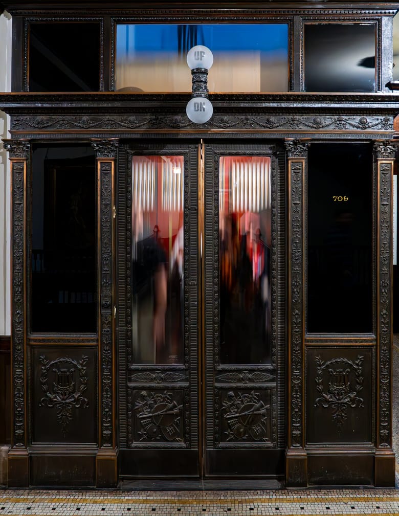 Image looking forward into a windowed elevator that is blurred by motion
