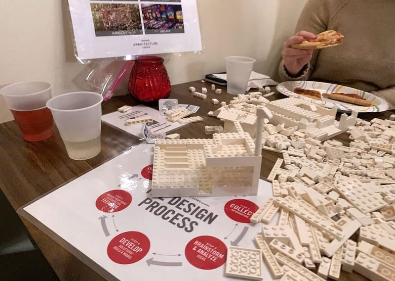 Close up of a LEGO build in progress with a Design Process worksheet on the table